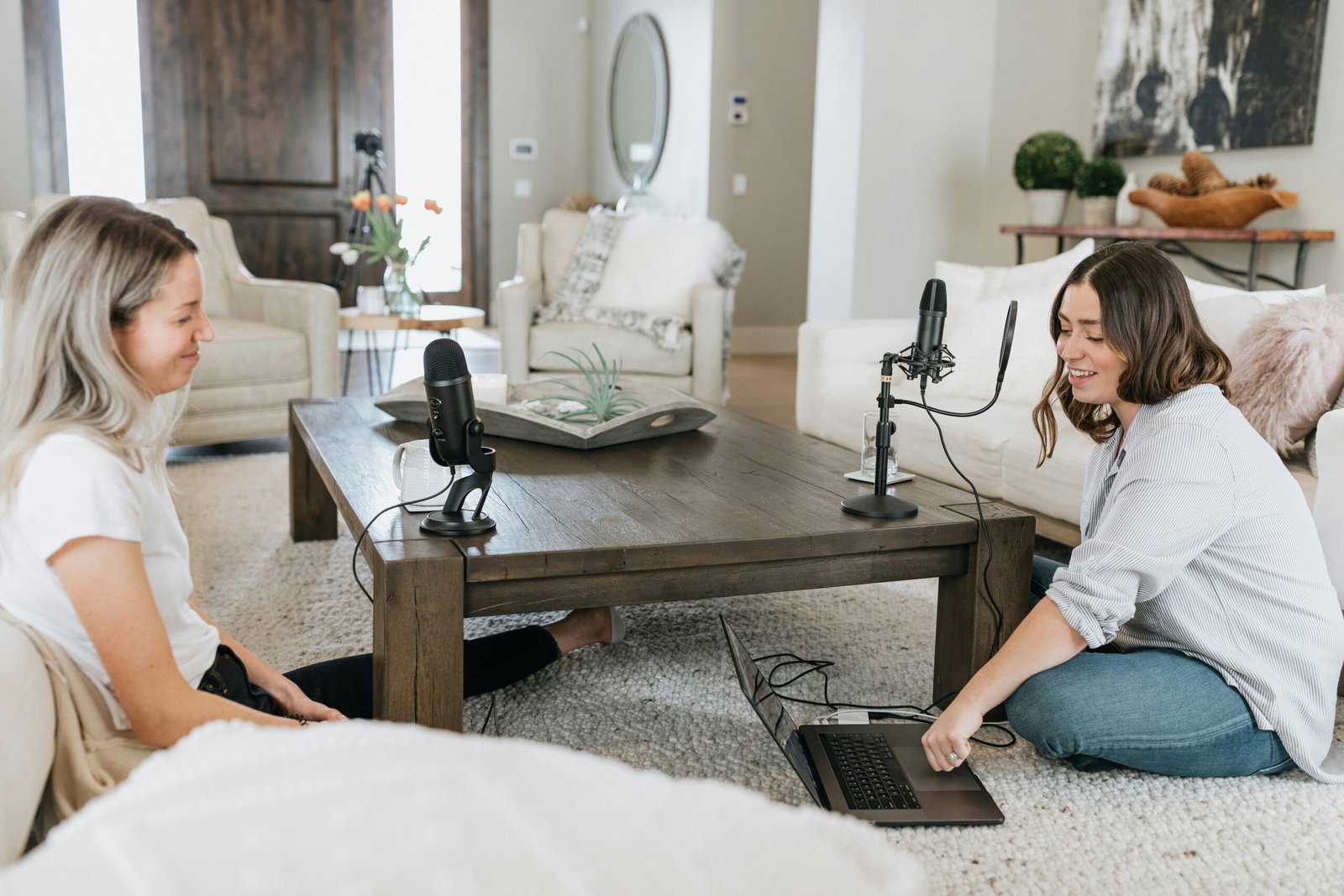 person in white shirt using black laptop computer on brown wooden table